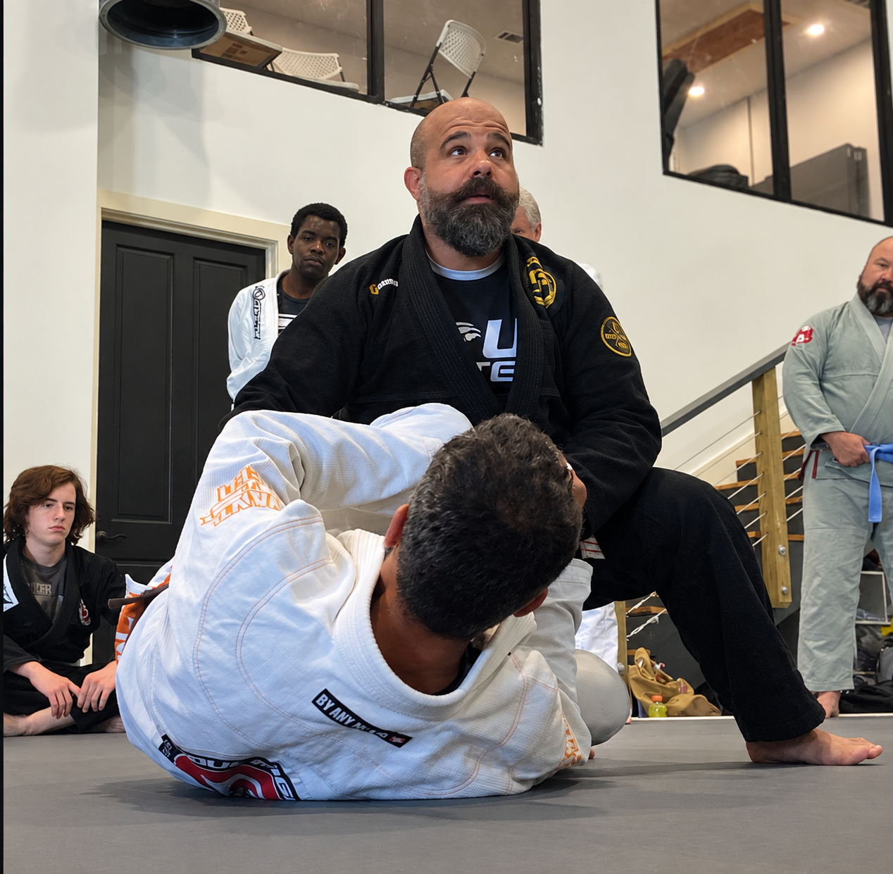Professor Tank demonstrating Brazilian Jiu-Jitsu with a student
