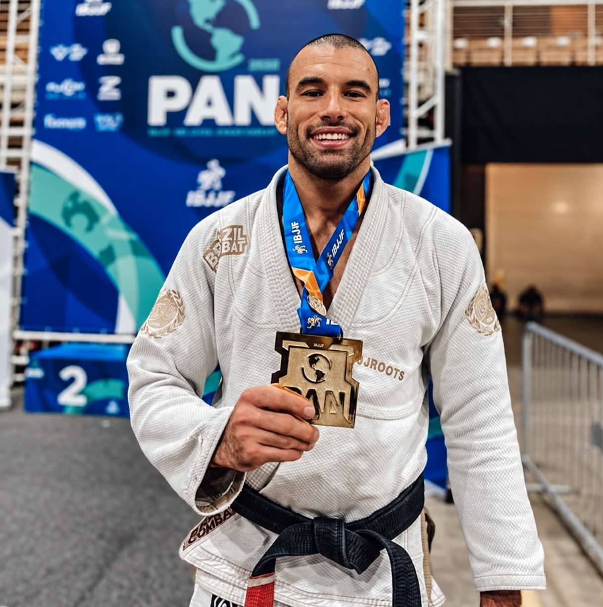 Professor Igor Paiva holding a Brazilian Jiu-Jitsu competition medal