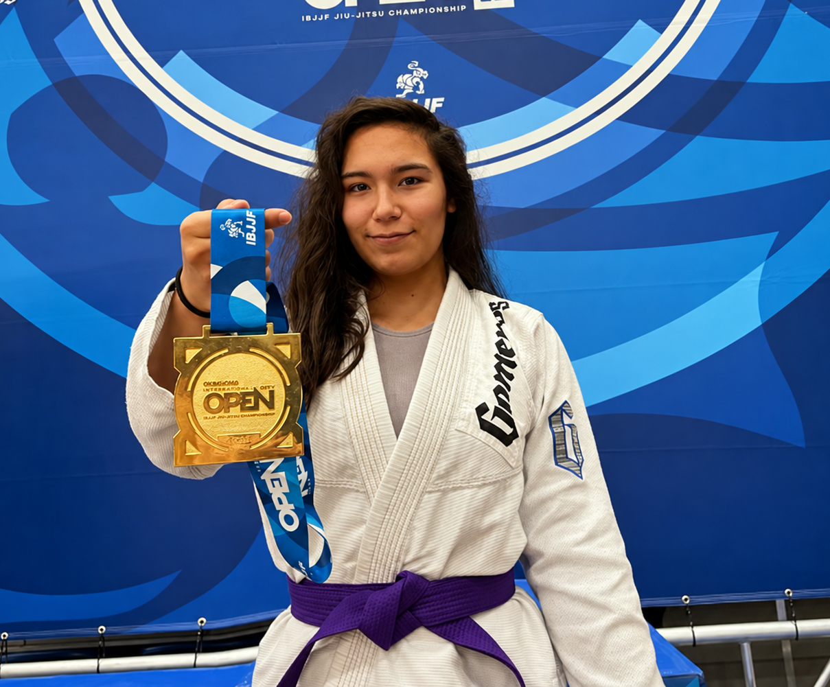 Madison “Maddie” Wolfe holding a Brazilian Jiu-Jitsu competition medal